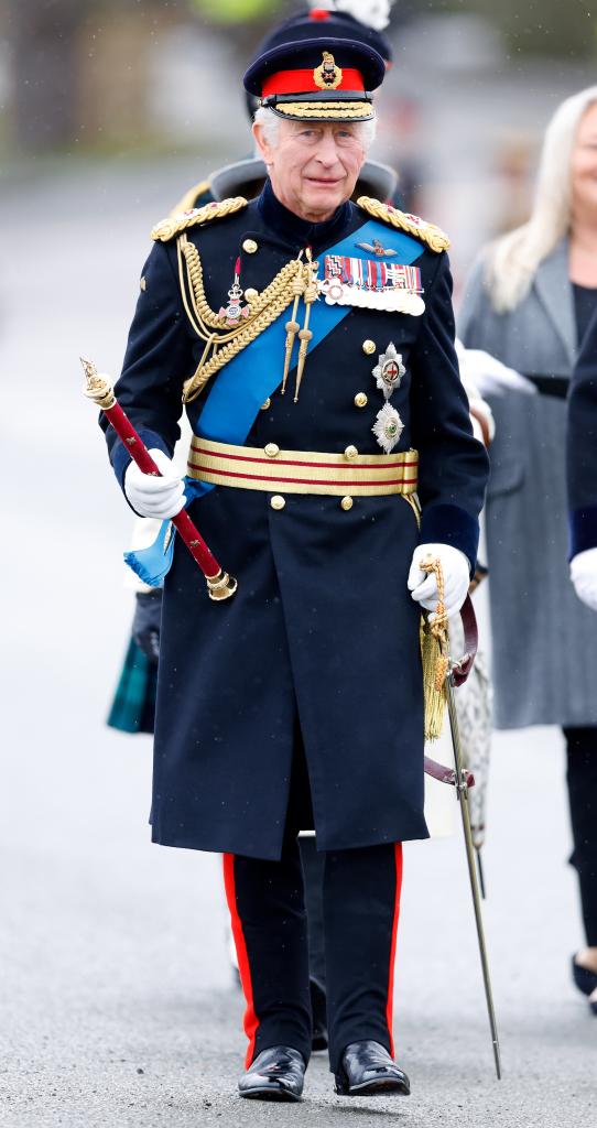 King Charles walks in military uniform