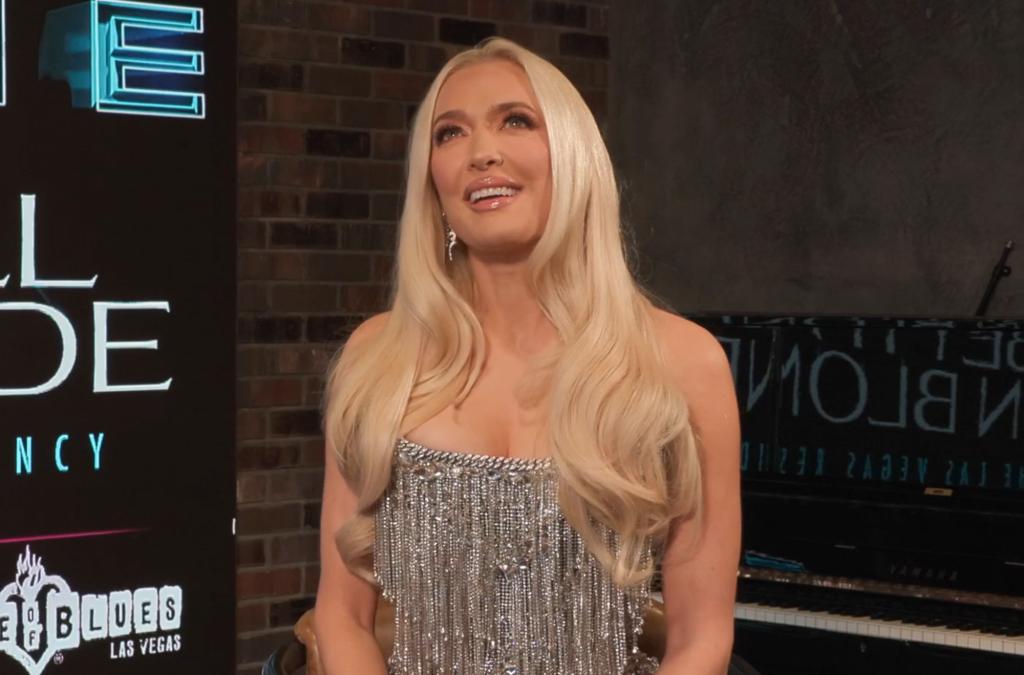 Erika Jayne sitting down in a sparkly dress