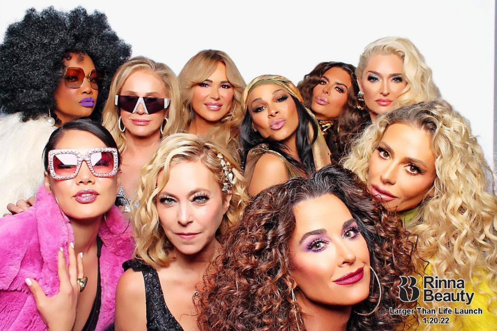 Garcelle Beauvais, Crystal Kung Minkoff, Kathy Hilton, Diana Jenkins, Sutton Stracke, Kyle Richards, Sheree Zampino, Lisa Rinna, Dorit Kemsley and Erika Jayne posing in front of a photo booth dressed in 1970s garb