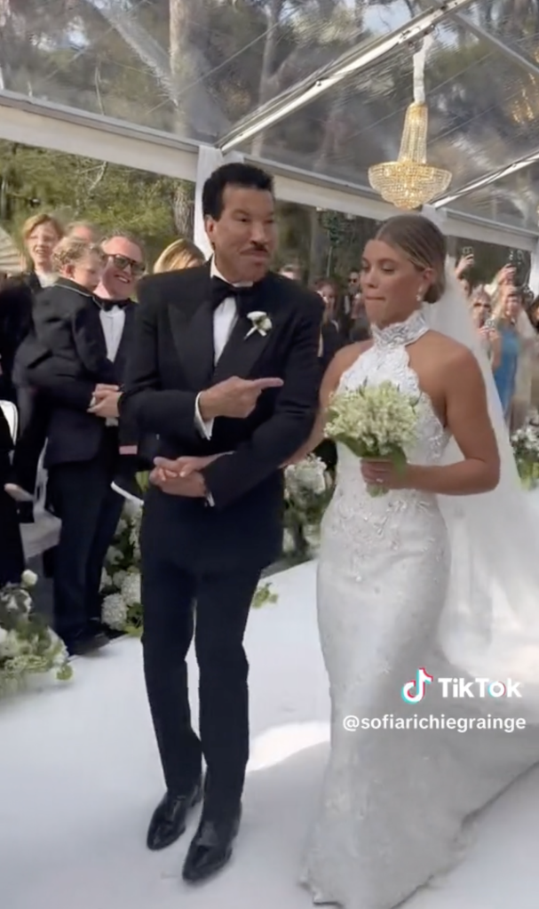 Sofia and Lionel Richie walking down the aisle.