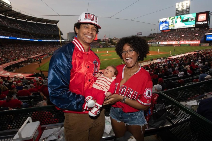 keke palmer holding her baby with her boyfriend at a baseball game