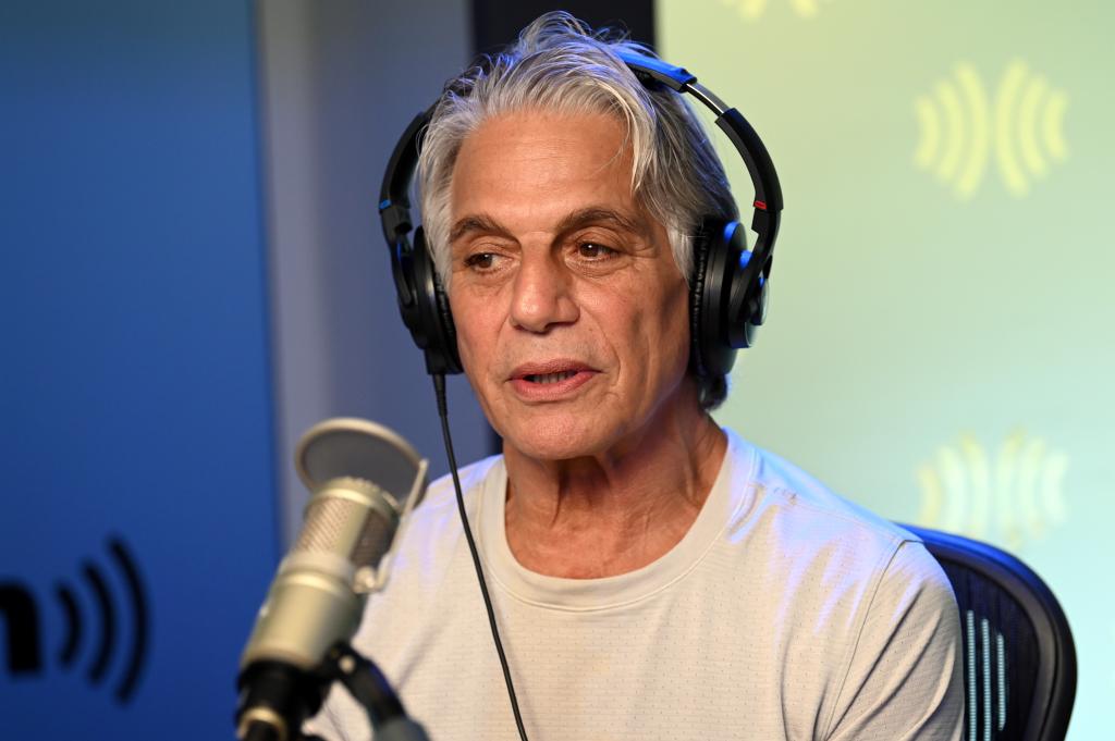 A close-up of Tony Danza wearing headphones and looking serious.