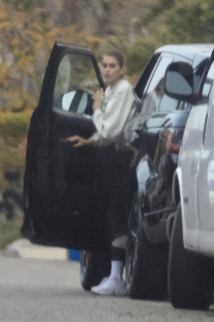 Kaia Gerber getting out of a car.