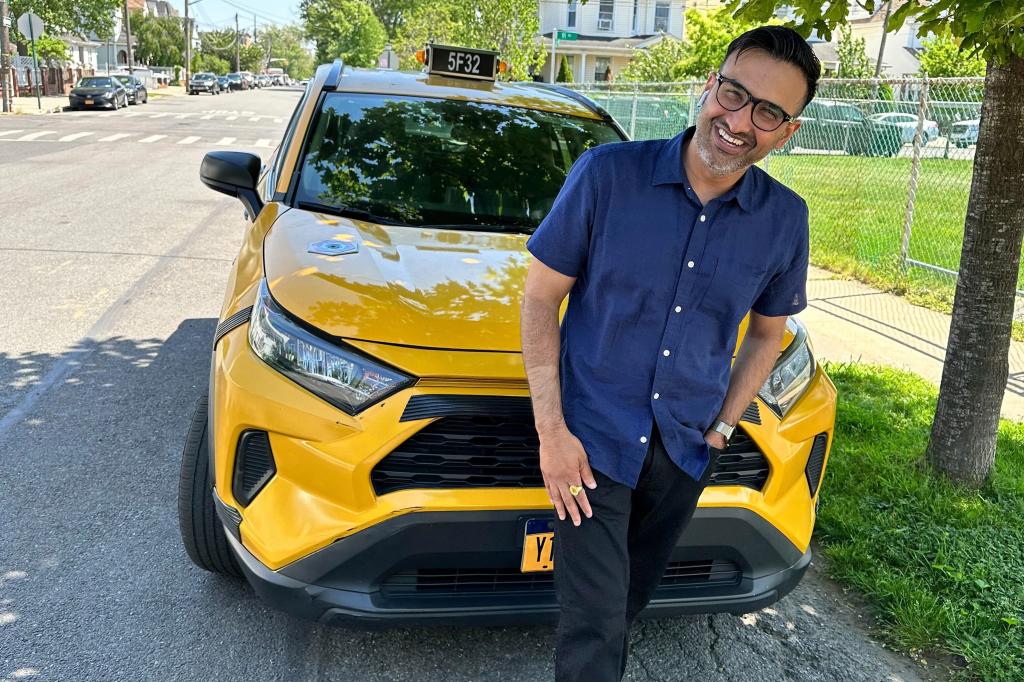 New York City cab driver Sukhcharn Singh posing with taxi