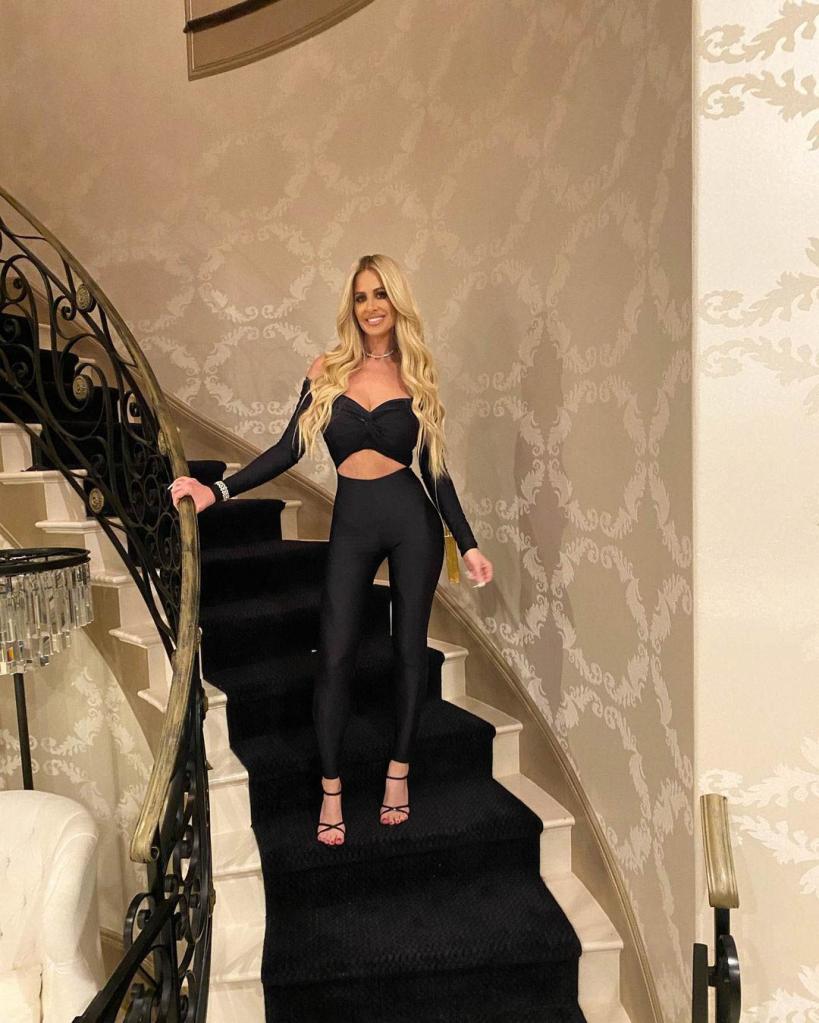 Kim Zolciak stands on stairs