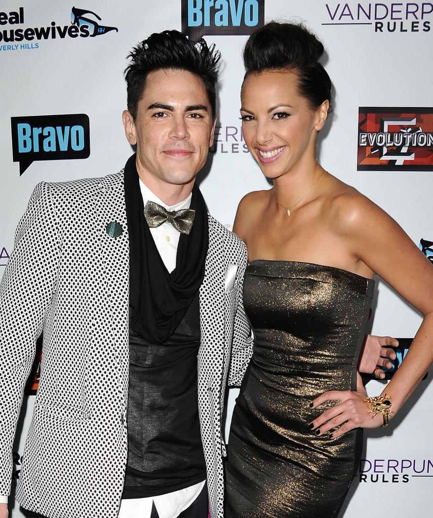 Tom Sandoval and Kristen Doute posing for a photo on a red carpet