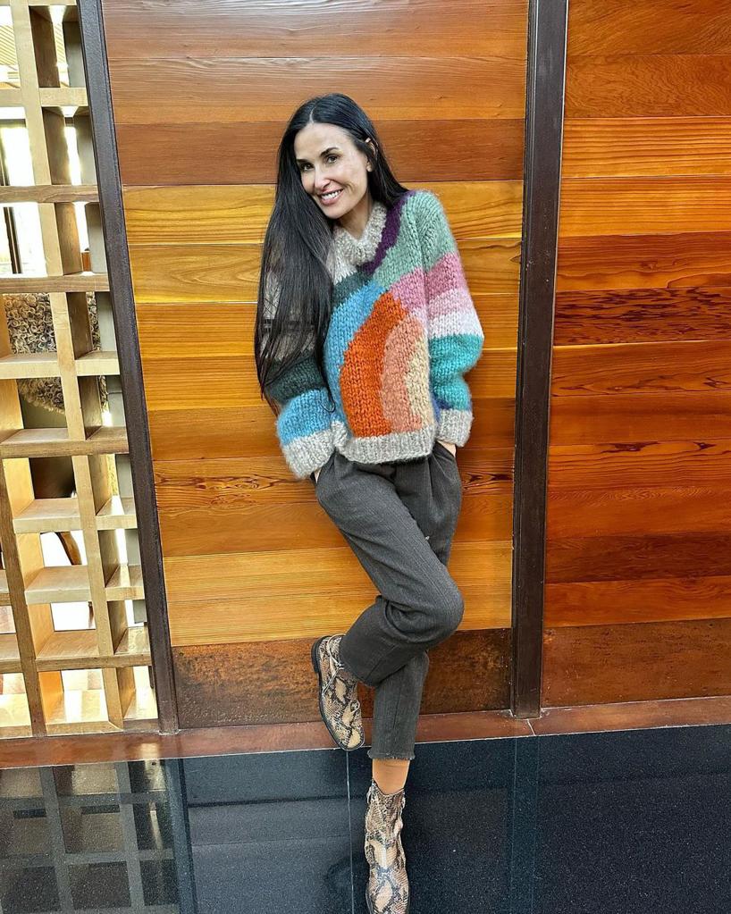 Demi Moore poses in colorful sweater
