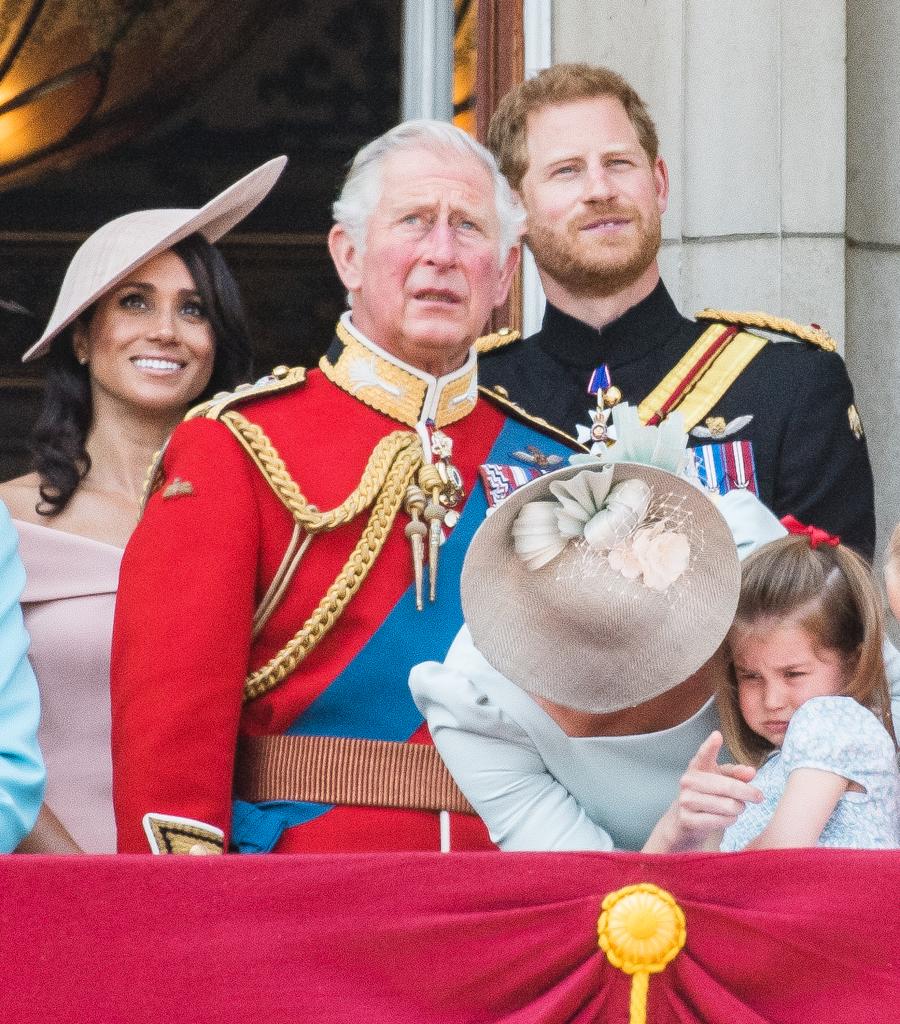 prince harry, meghan markle and king charles iii on a balcony