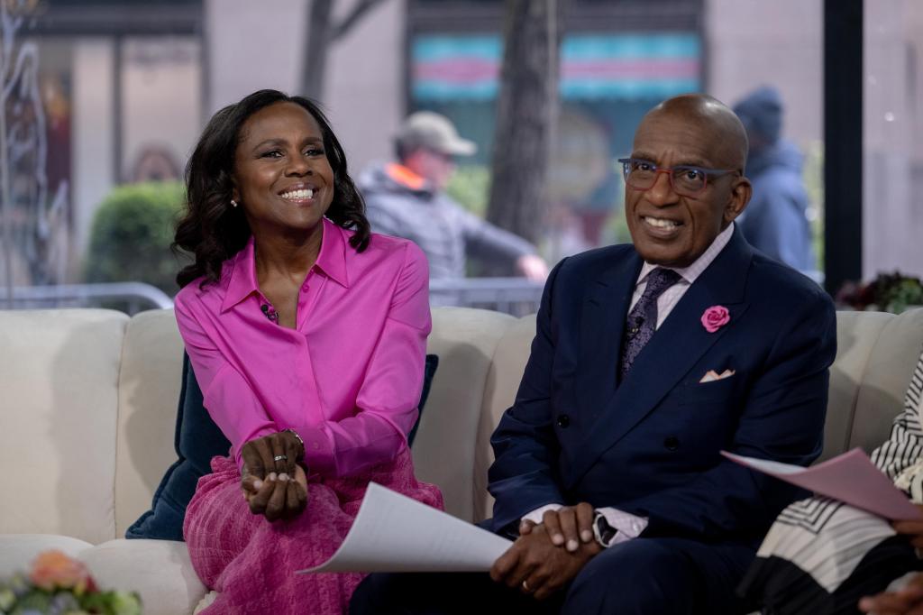 Robin Roberts in purple on left and Al Roker on the left in a suit smiling.