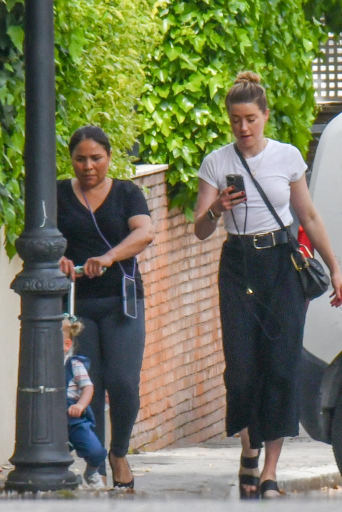 Amber Heard walking around Madrid with her child and a caretaker.