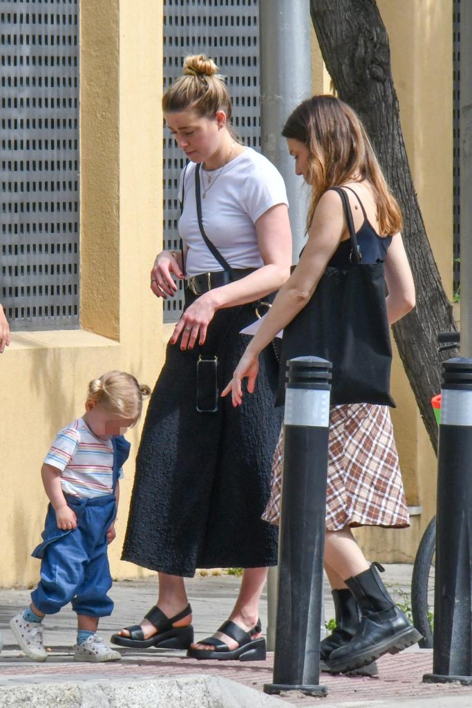 Amber Heard hanging out with her daughter and a friend in Madrid.