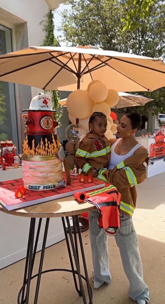 Kim Kardashian holds son Psalm next to cake