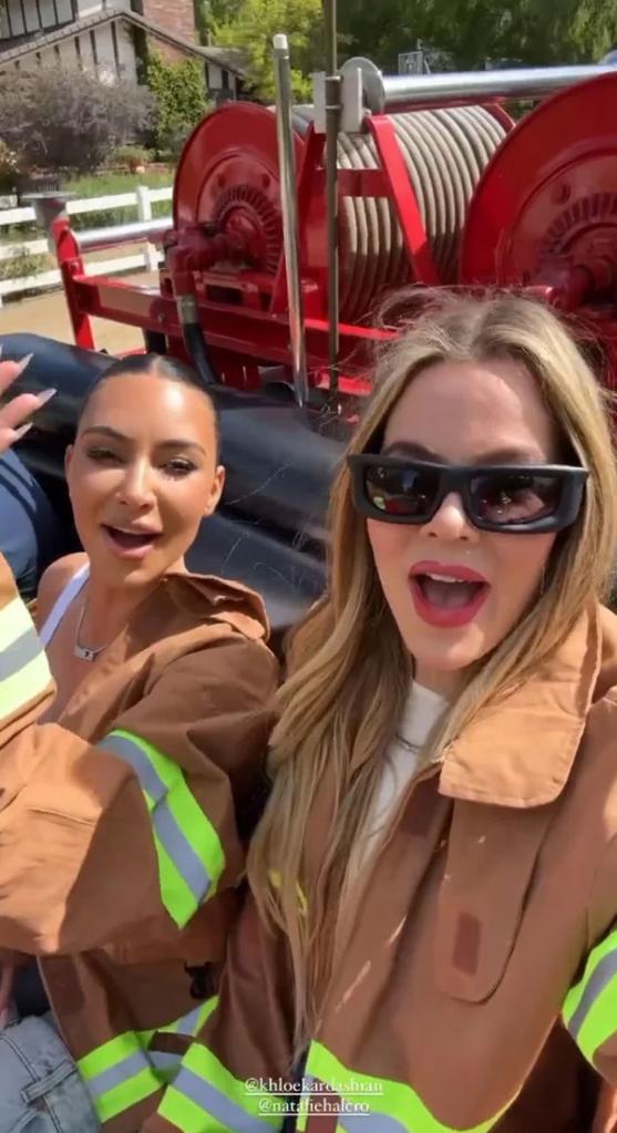 Kim Kardashian and Khloé Kardashian ride in firetruck