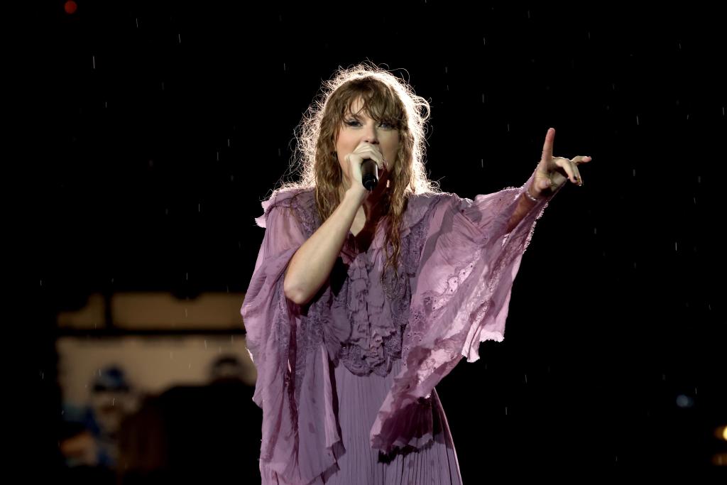 Taylor Swift performs in purple