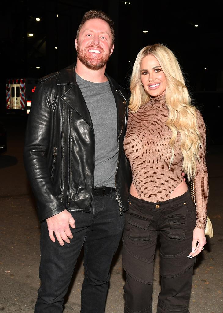 Kim Zolciak stands with Kroy Biermann