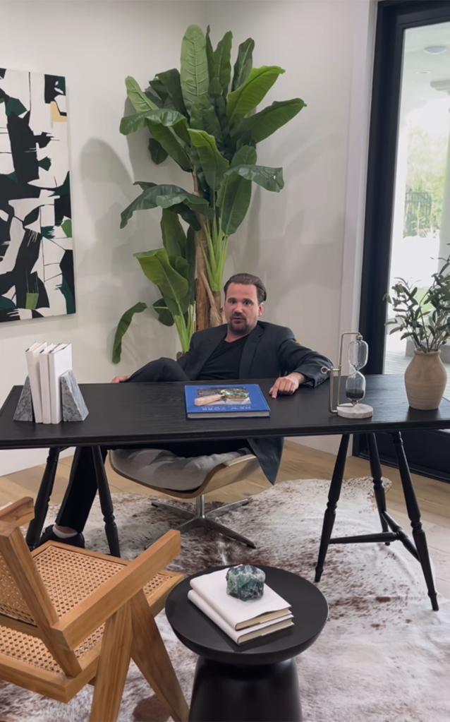 rod stewart's son sean sitting at a desk