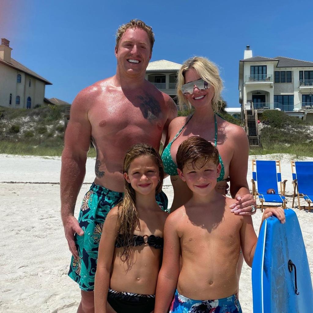 Kim Zolciak and Kroy Biermann posing with their four kids at the beach.