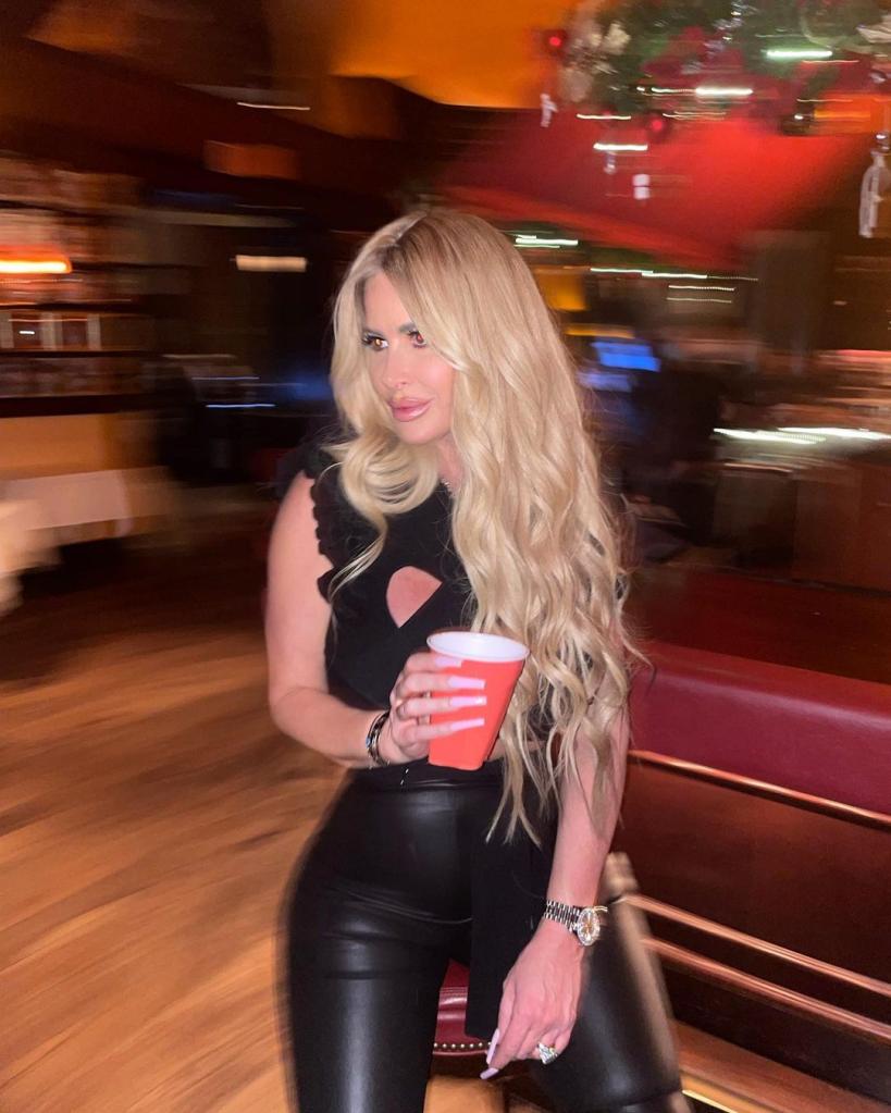 Kim Zolciak holding a red solo cup.