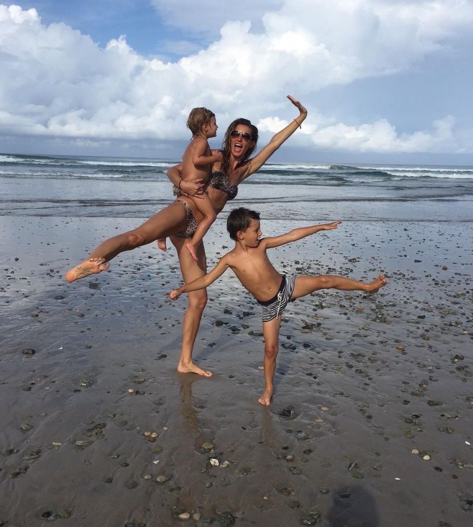 Gisele Bündchen on a beach with her two kids.