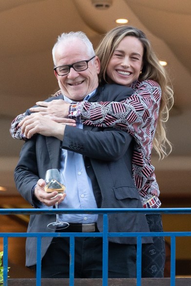 brie larson hugs thierry fremaux from behind