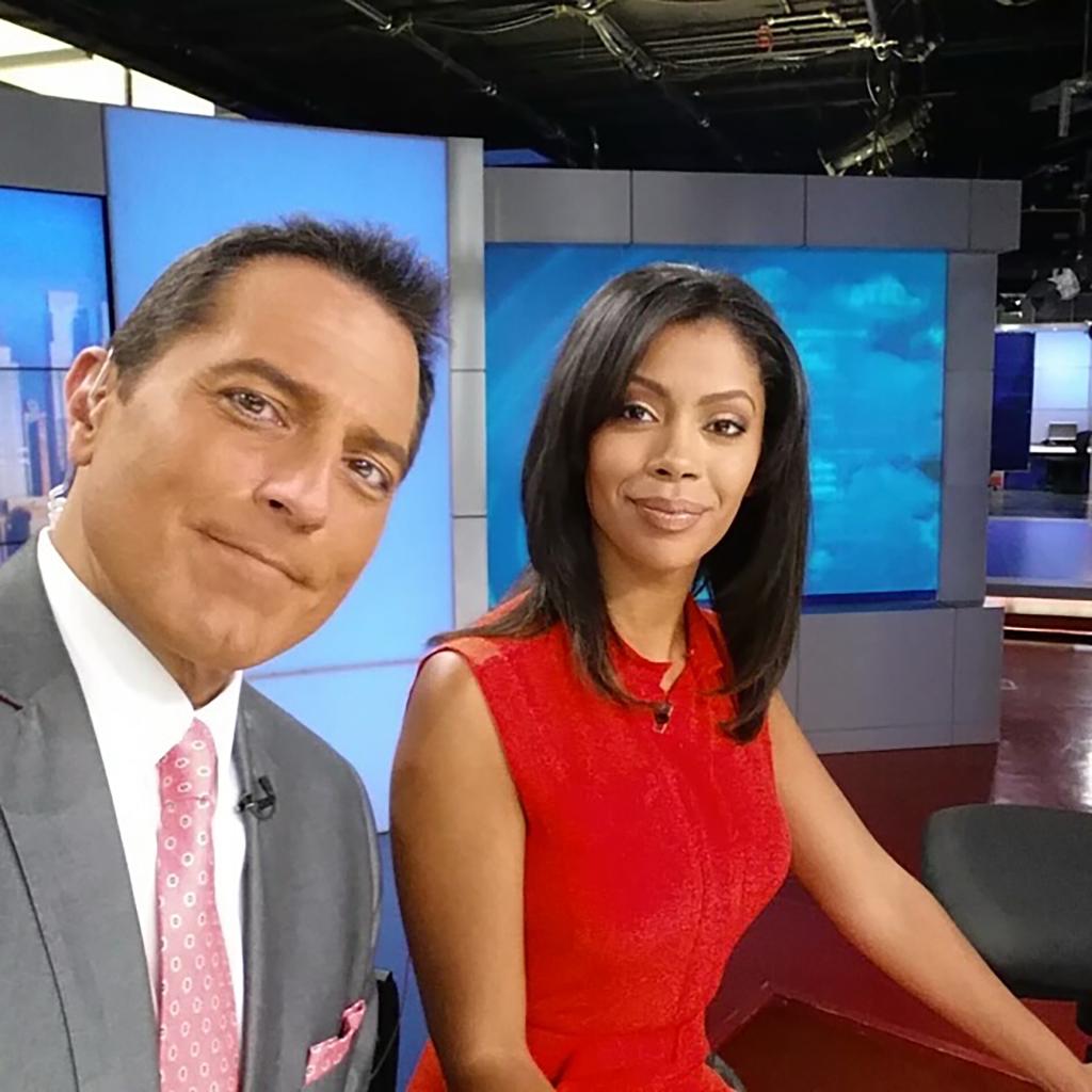 Ken Rosato and Shirleen Allicot posing at the anchors' news desk together.