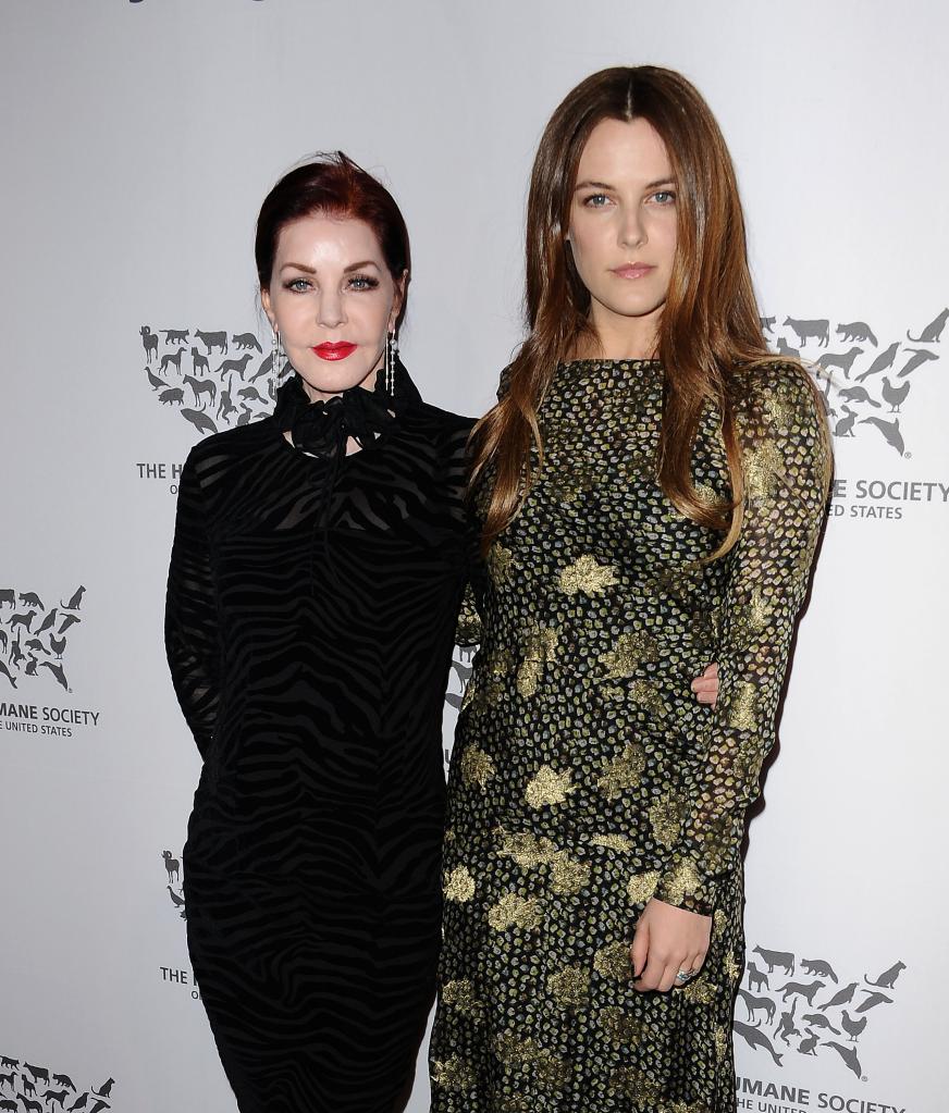 Priscilla Presley posing with Riley Keough at a red carpet event.