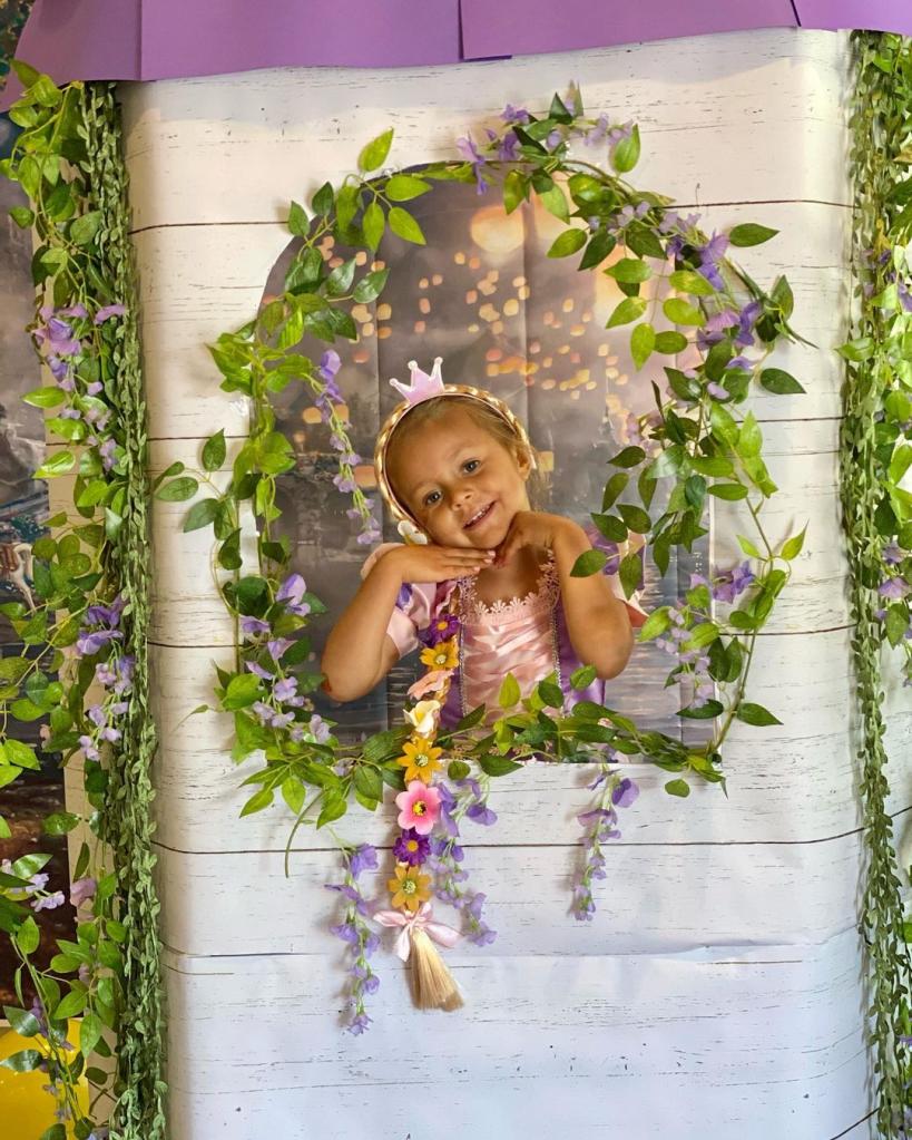 alfonso ribeiro's daughter dressed as a princess looking out a fake window