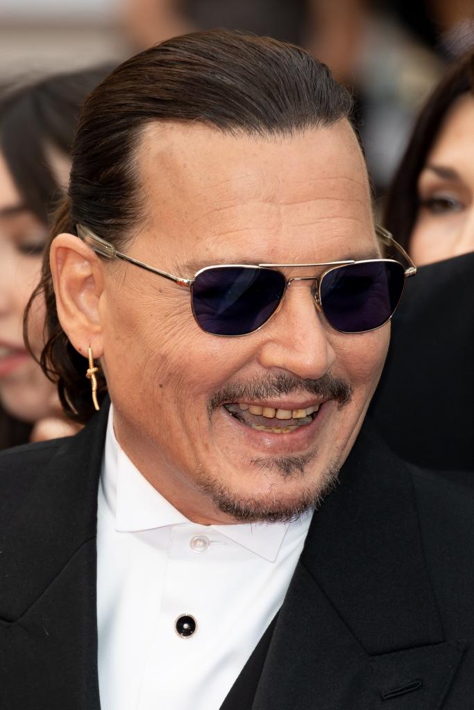 Johnny Depp smiles in glasses