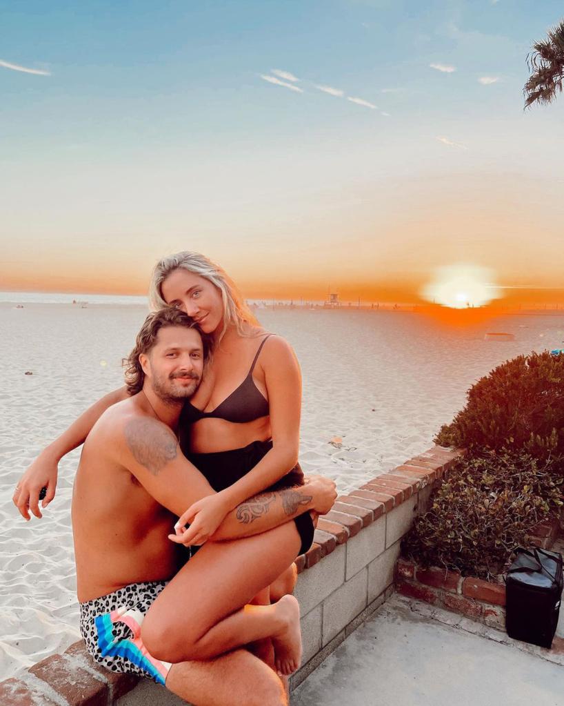 Ruby Stewart poses at beach with fiancé Jack