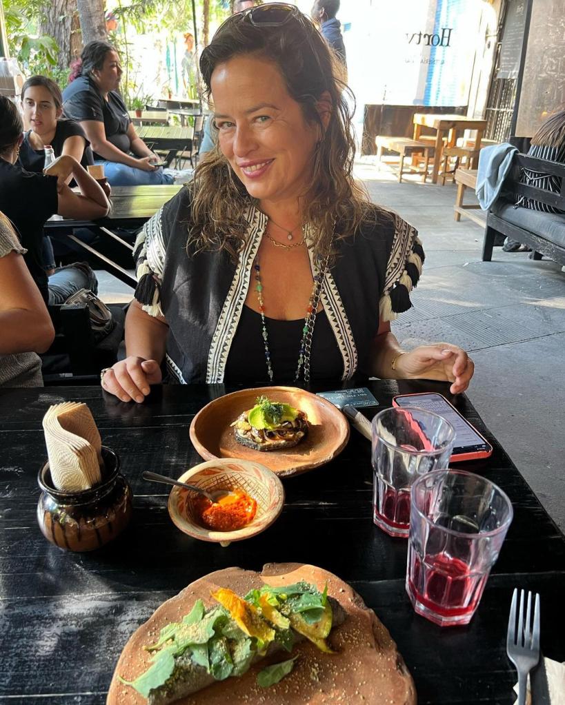 Jade Jagger sitting at a table.