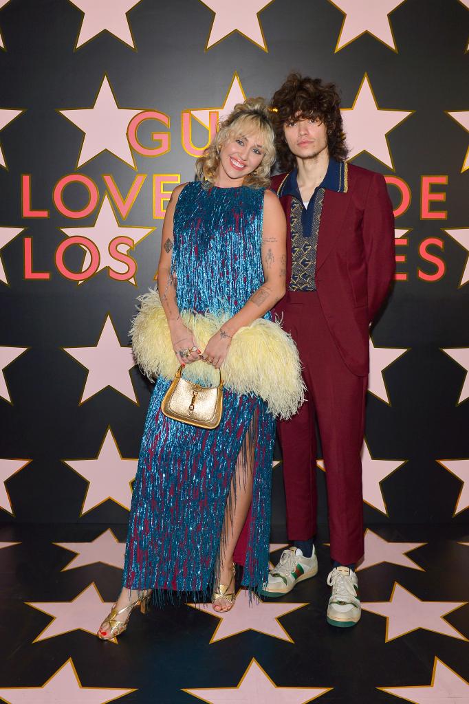 Miley Cyrus and Maxx Morando pose at a Gucci 