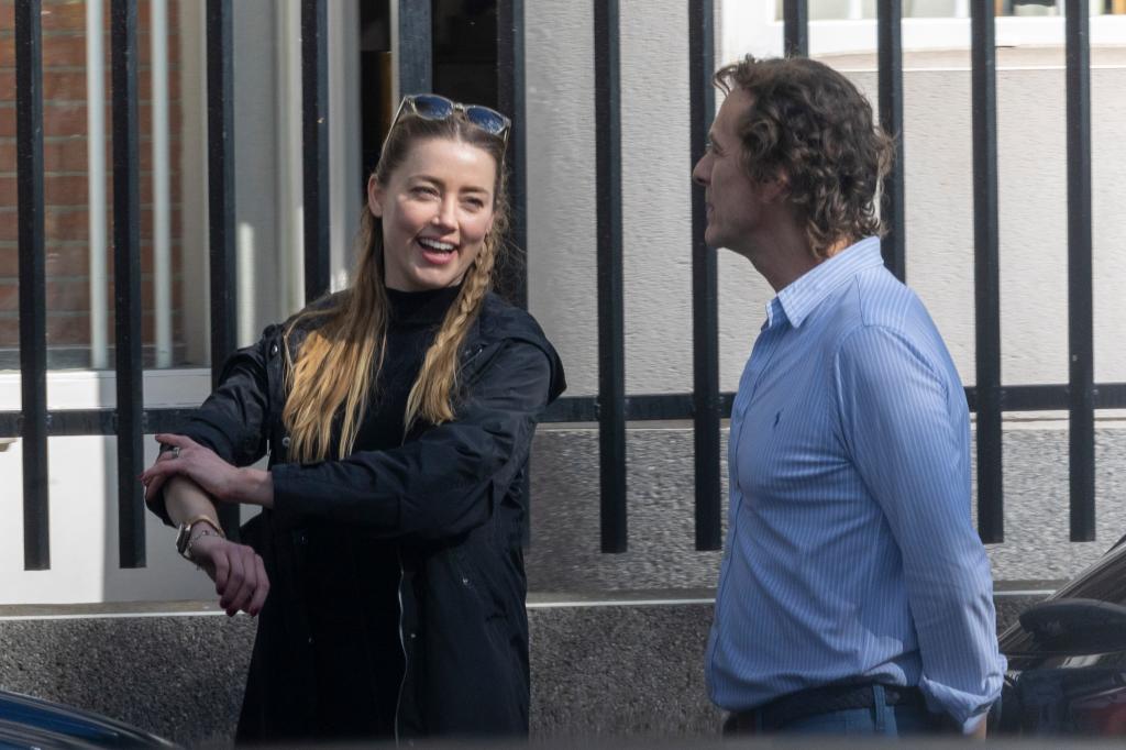 Amber Heard smiles in Madrid wearing black