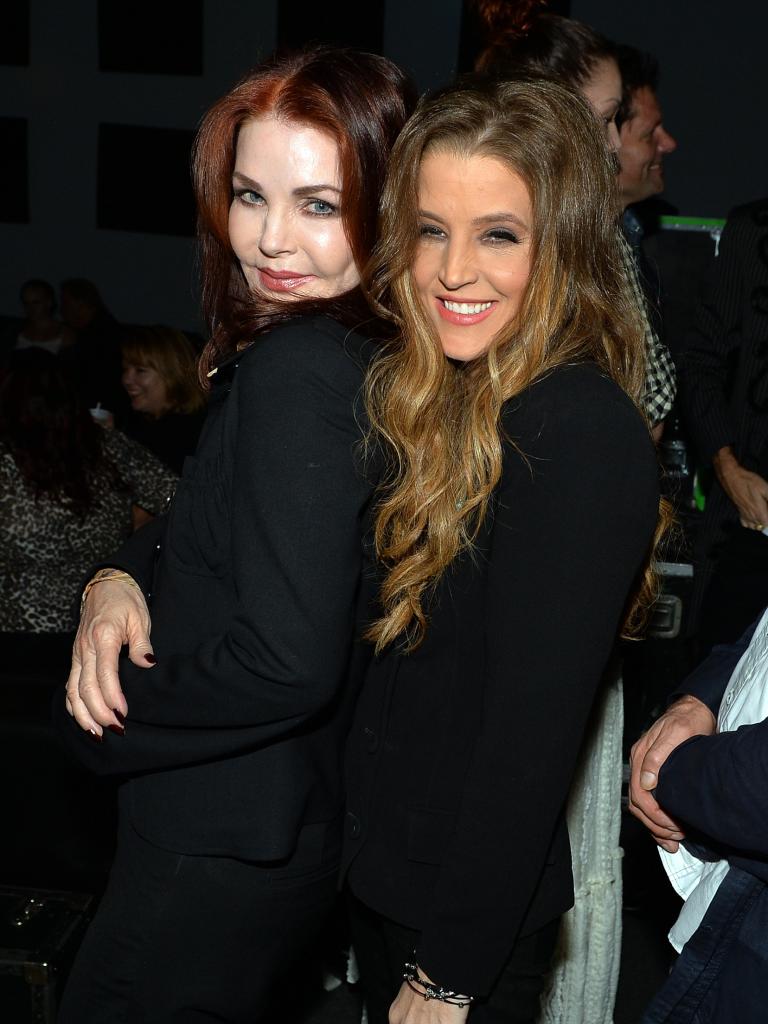 Lisa Marie Presley and Priscilla Presley hugging.