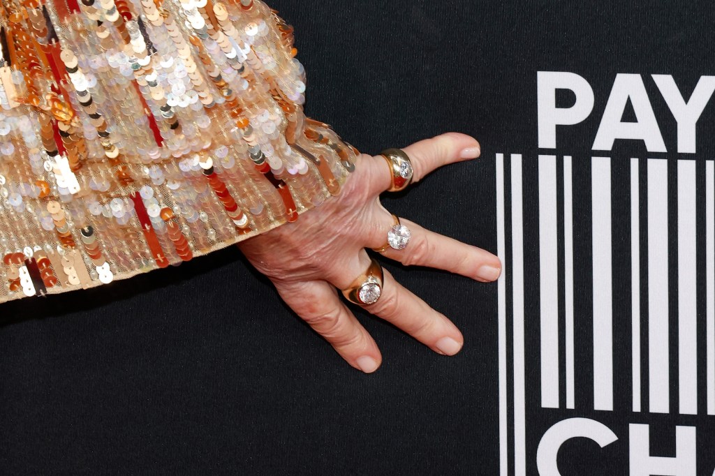 Martha Stewart's hand wearing rings. 