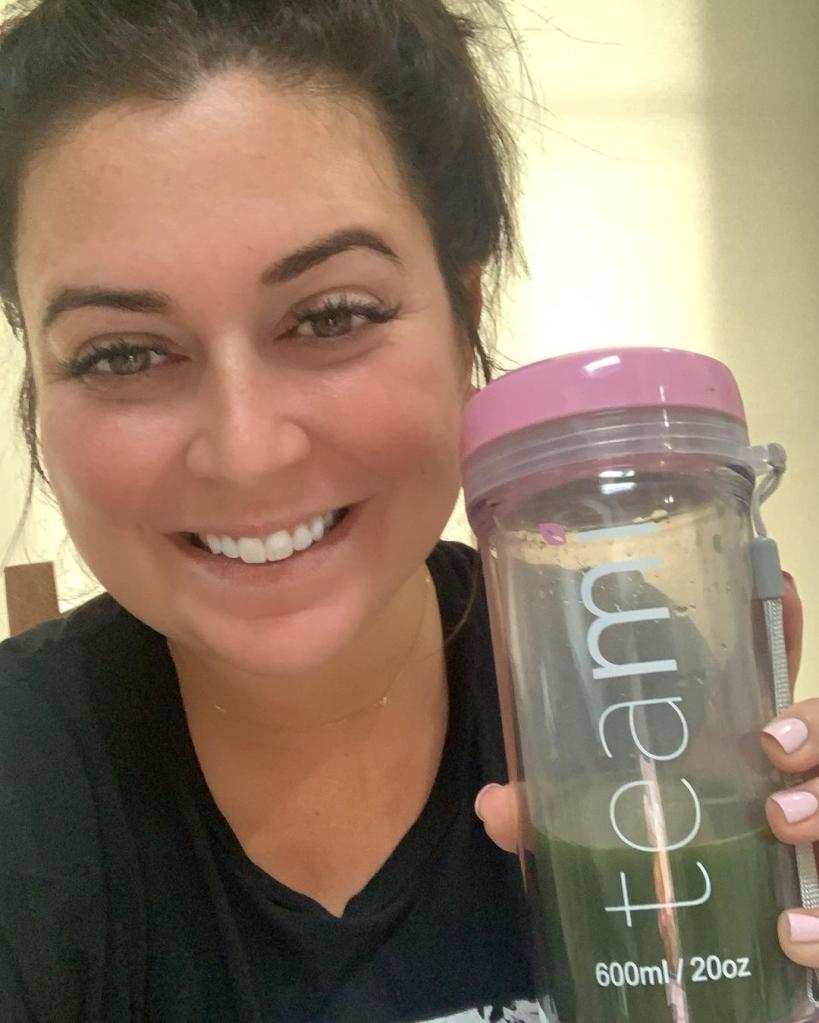 Lauren Manzo holding up a protein shake container.