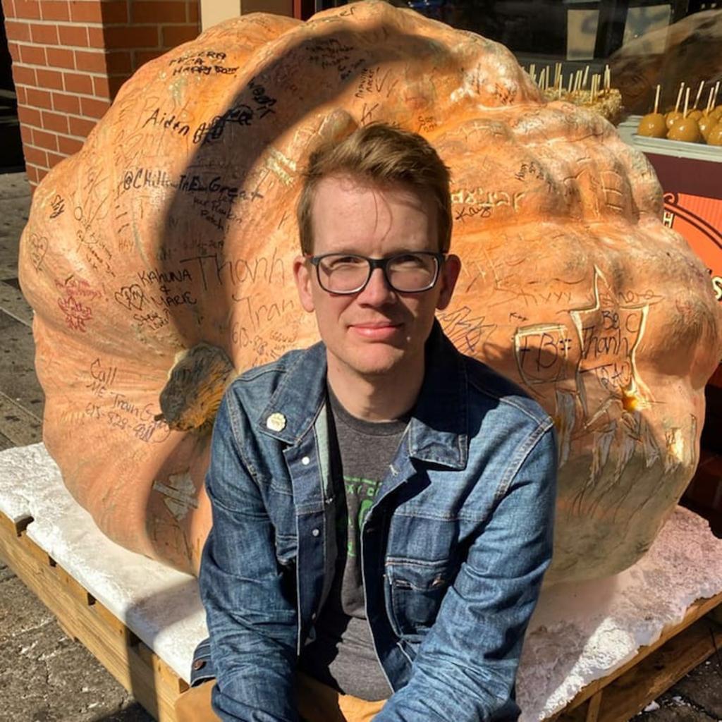 Hank Green poses in denim jacket