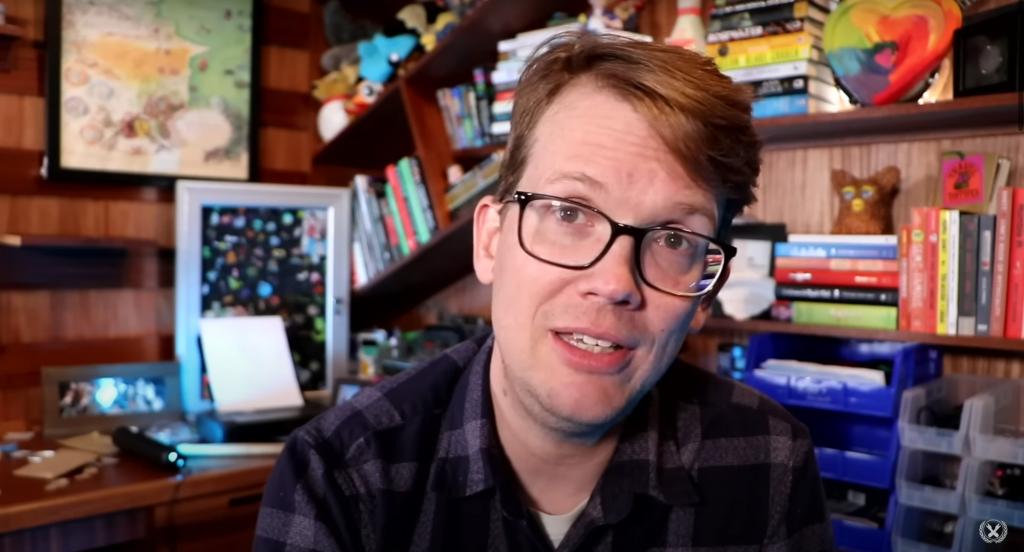 Hank Green speaks in office