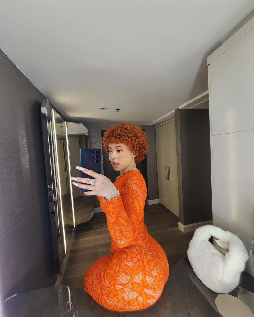 Ice Spice takes mirror selfie in orange