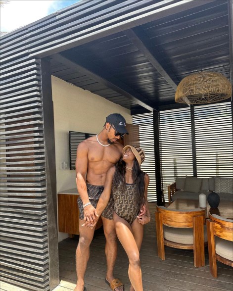 jonathan owens and simone biles looking up at each other in a hut