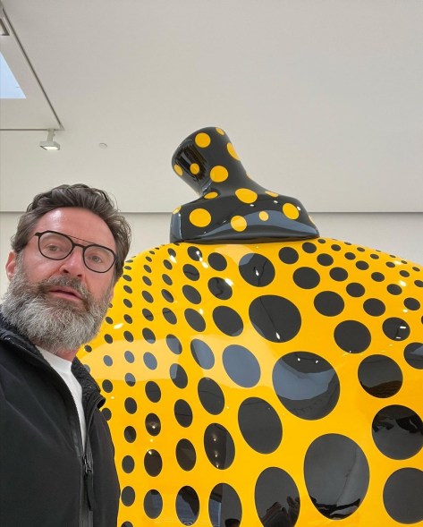 hugh jackman selfie with a black and yellow sculpture