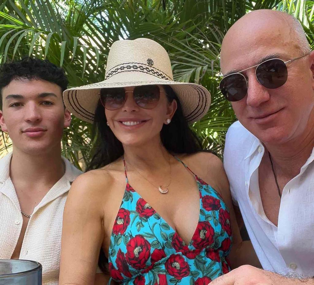 Jeff Bezos and Lauren Sánchez posing for a photo with her son.