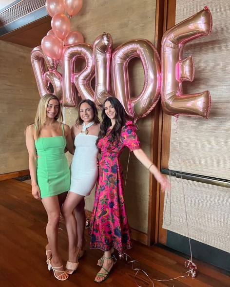 nina dobrev and two friends standing below "bride" balloons