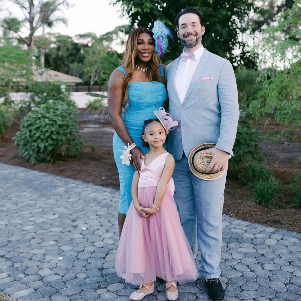 Serena Williams standing with her husband, Alexis Ohanian, and daughter Olympia.