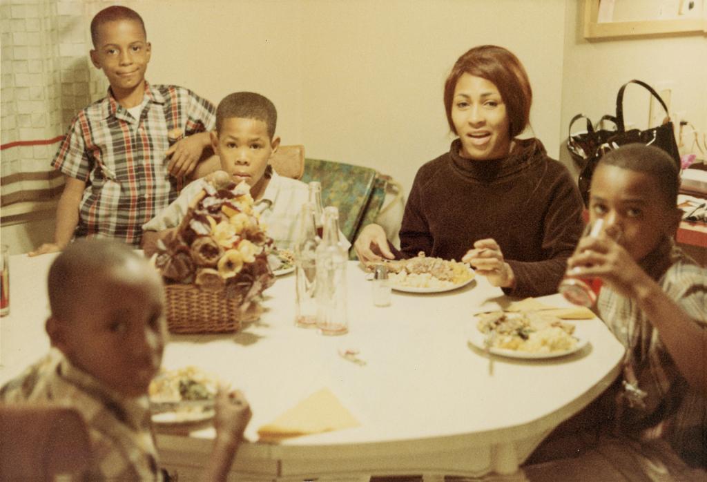 Tina Turner at a dinner table with her family.