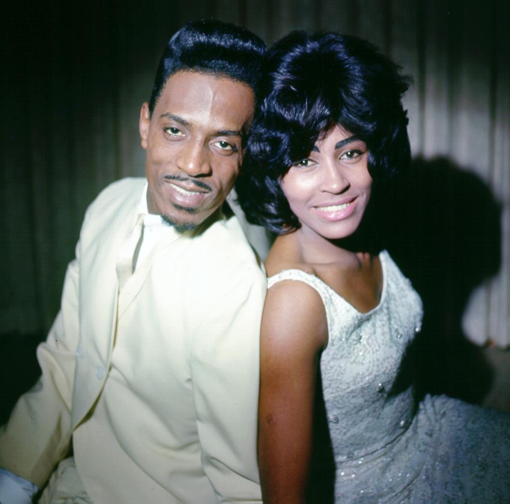 Tina and Ike Turner posing back to back.