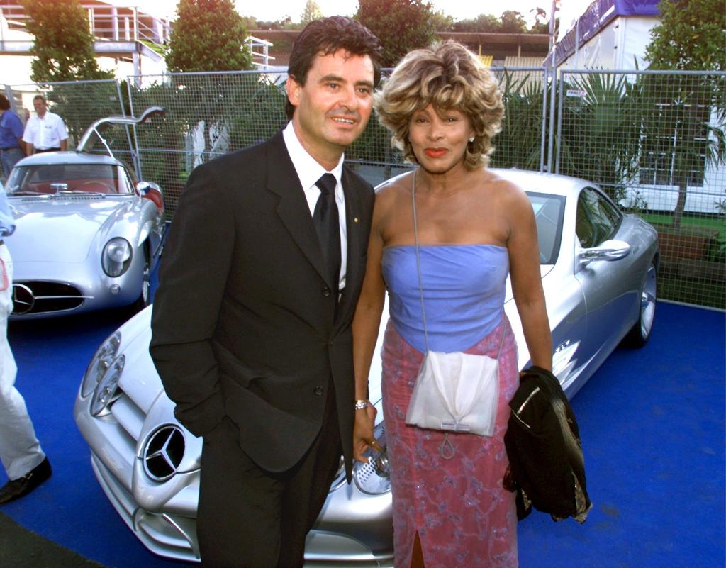 Tina Turner and Erwin Bach together in front of car in 1999