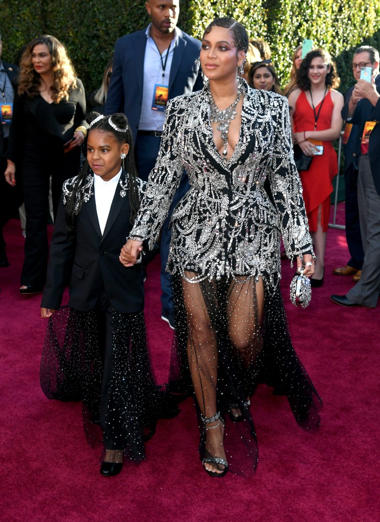 Blue Ivy and her mom, Beyoncé, walking a red carpet together.