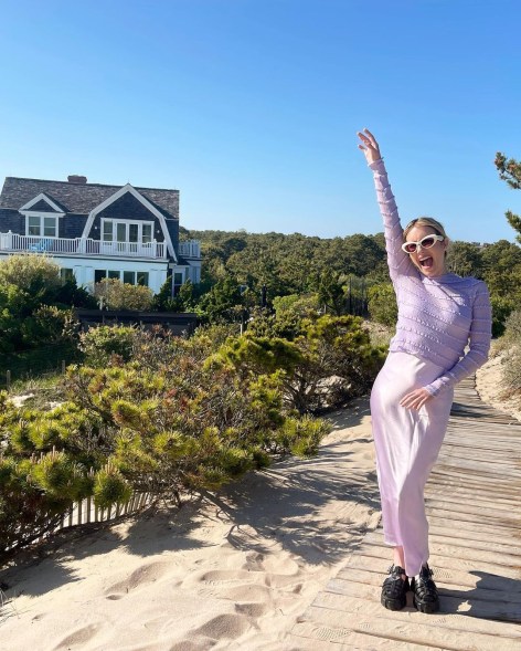 emma roberts in front of a house