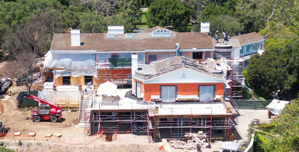 Men working on the roof of Jeff Bezos' Beverly Hills mansion.