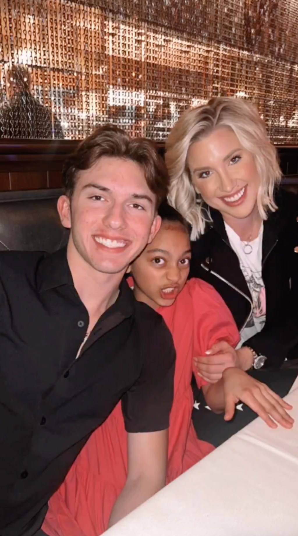 Savannah Chrisley with brother and niece, smiling